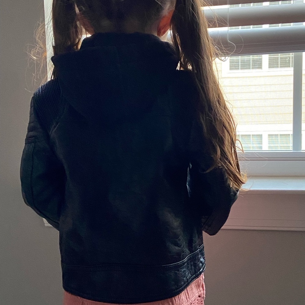 Gently used black leather jacket with a hood